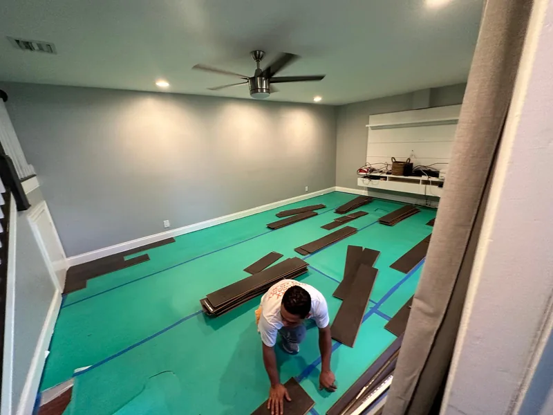 Flooring piece being positioned during installation