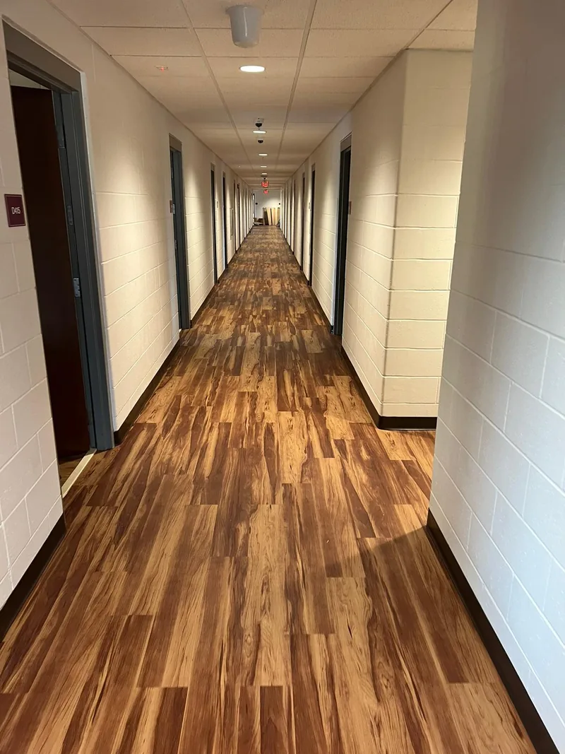 Corridor passing one doorway after another, the plank run continuing without a break
