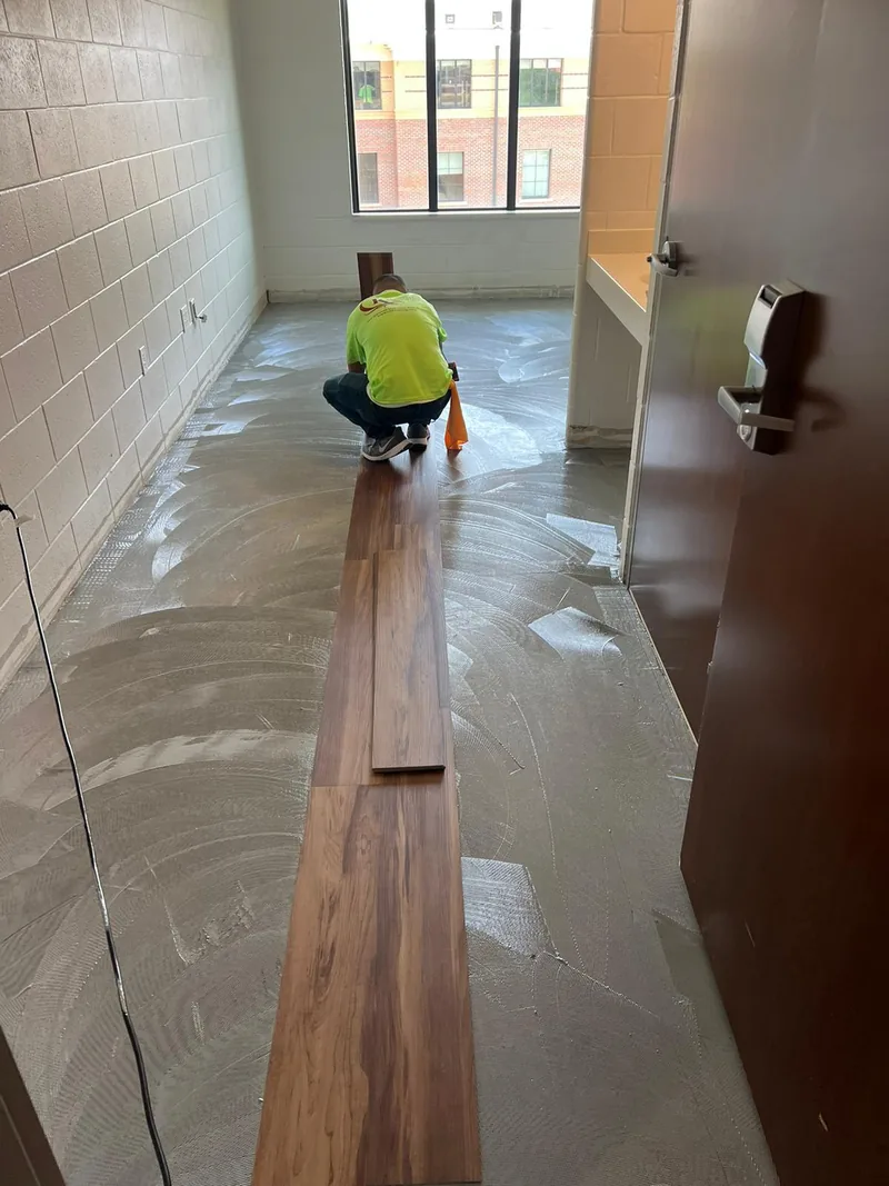 Installer setting the first row of flooring to the line