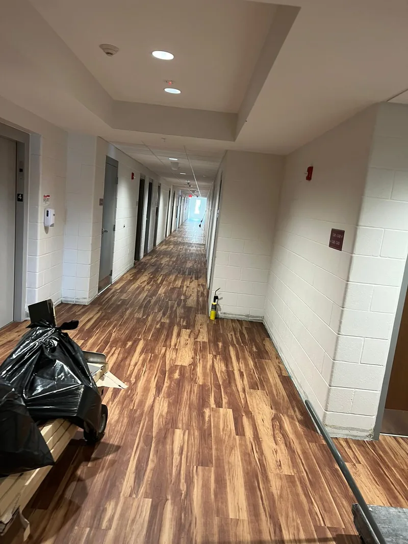 Fourth-floor elevator lobby with the flooring finished and the last debris still being cleared