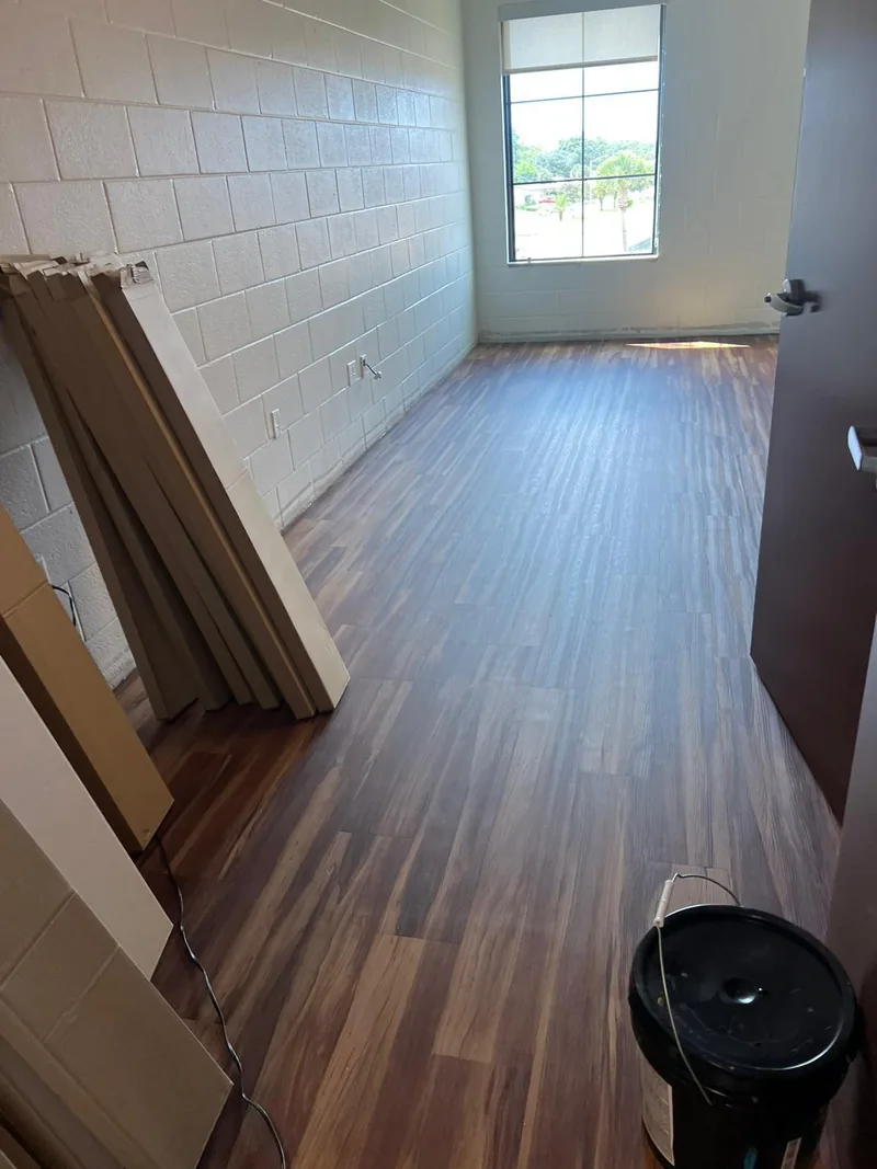 Finished dormitory room with the flooring turning in from the corridor
