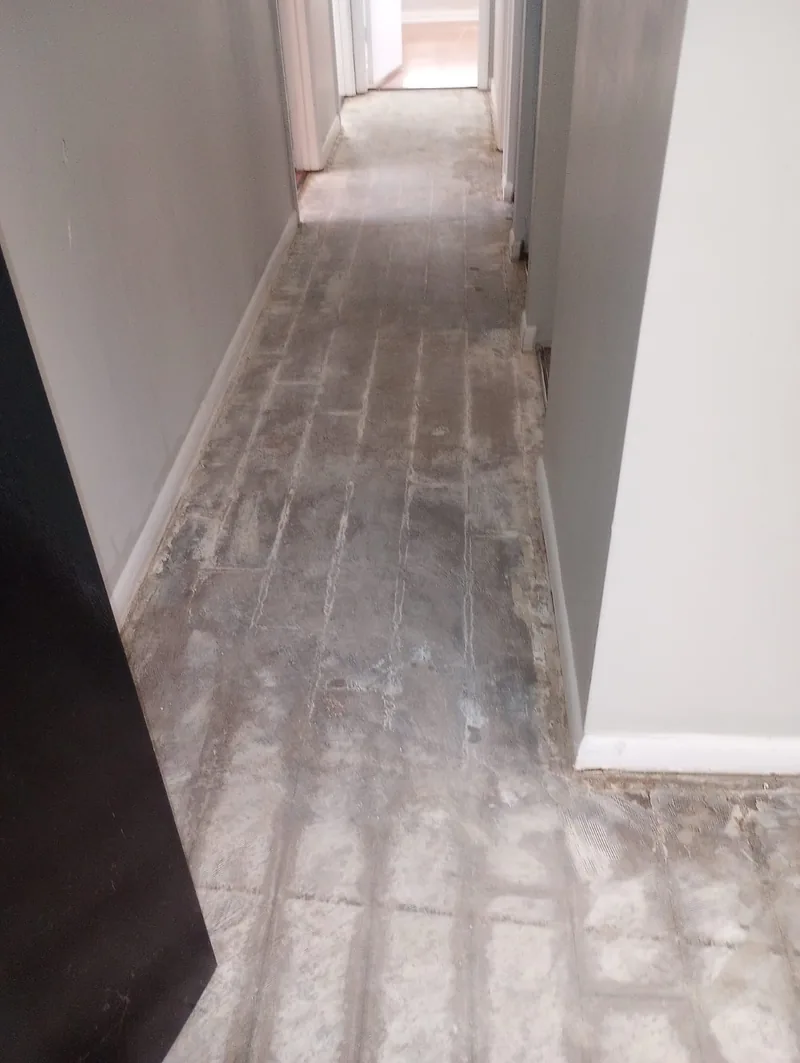 Corridor with the old floor removed and the concrete base exposed