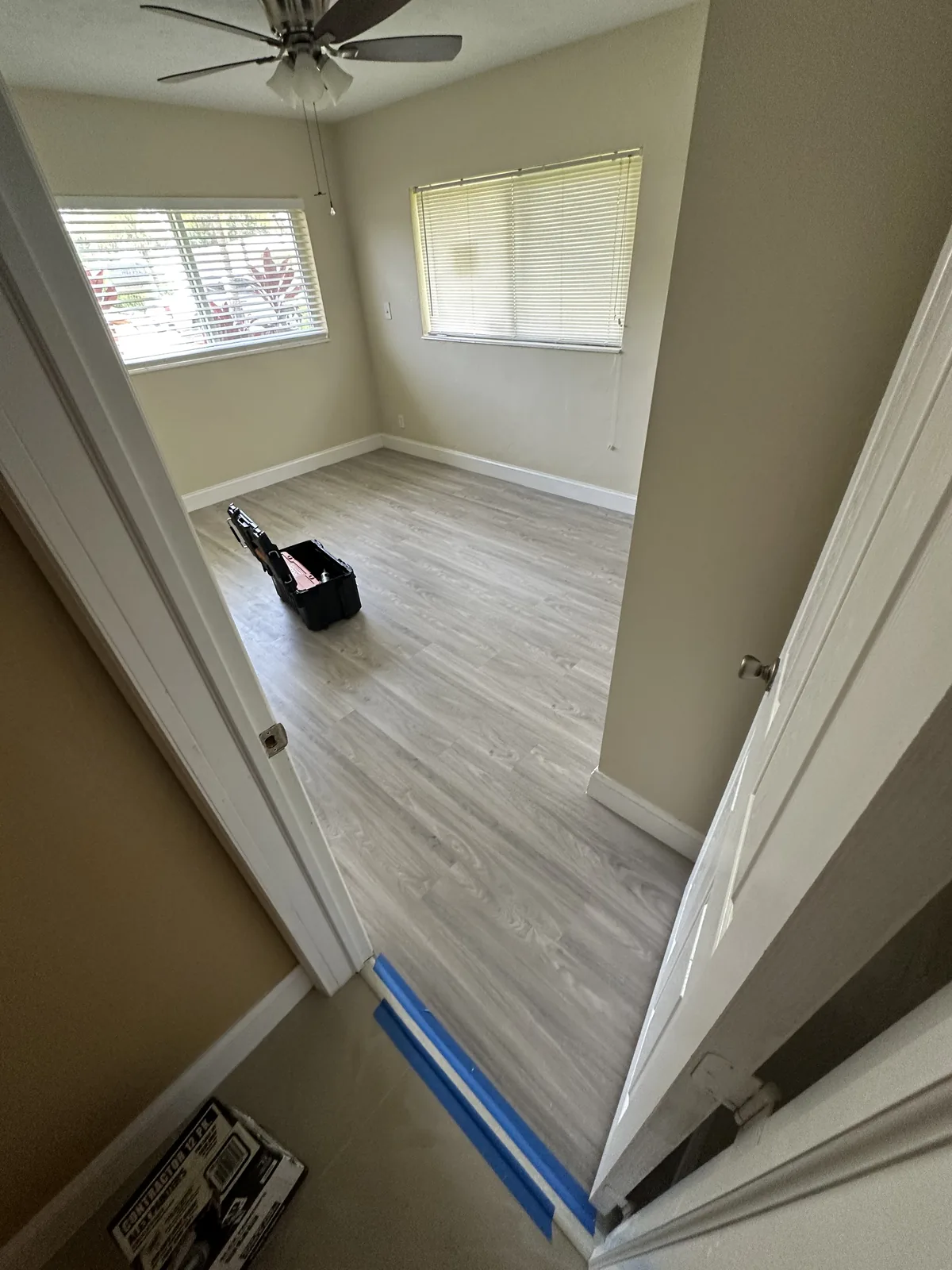 Corridor connecting adjoining rooms with flooring in place
