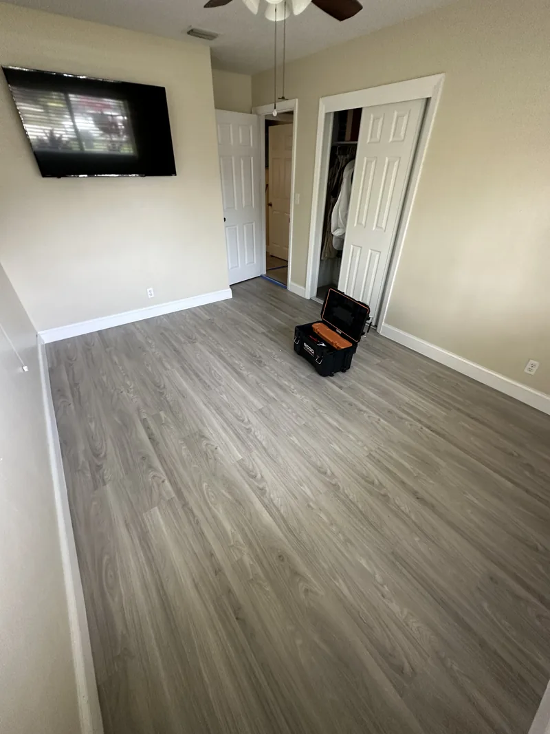 Bedroom and open closet with flooring in place