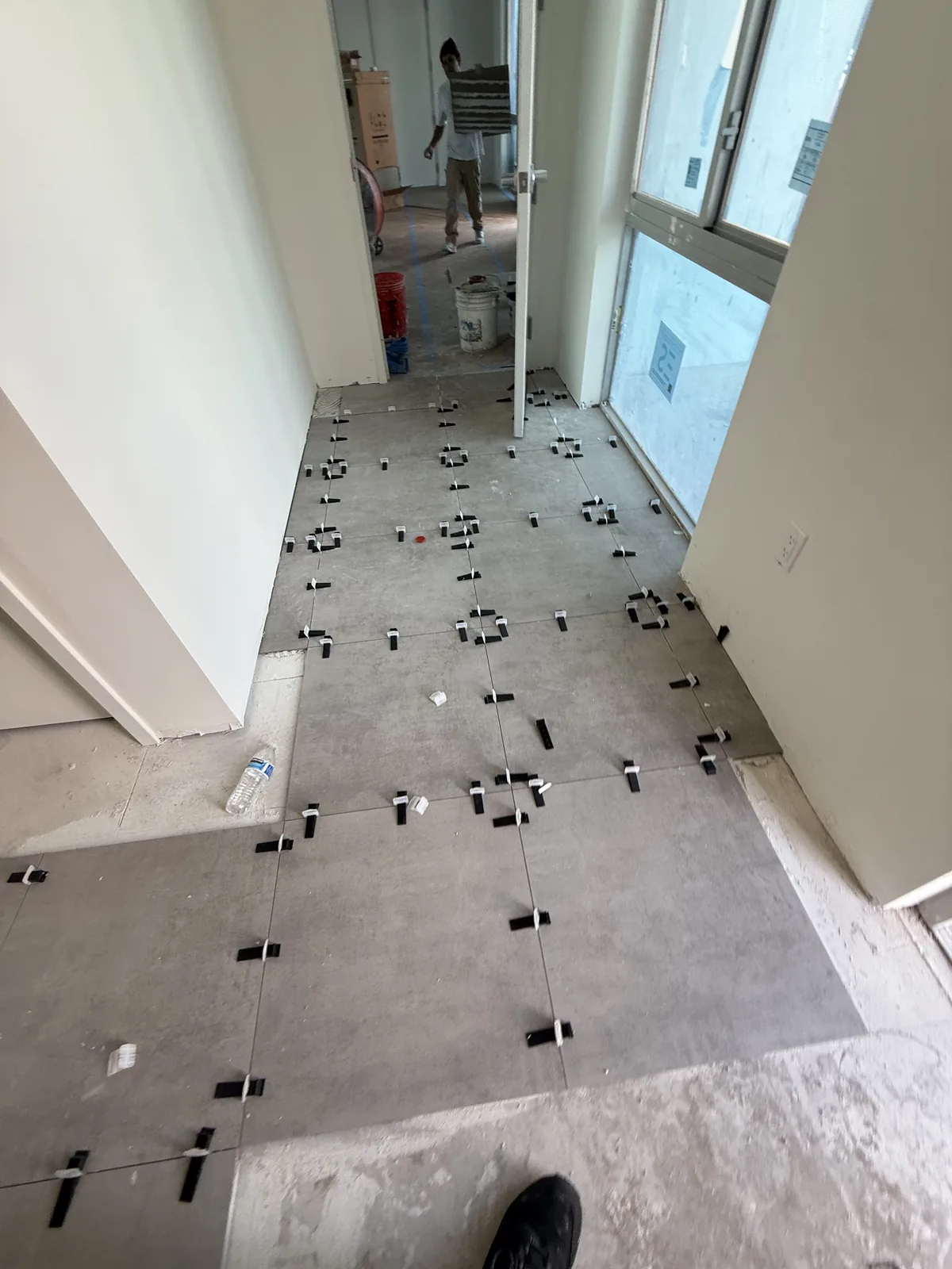 Corridor installation in progress with leveling clips visible