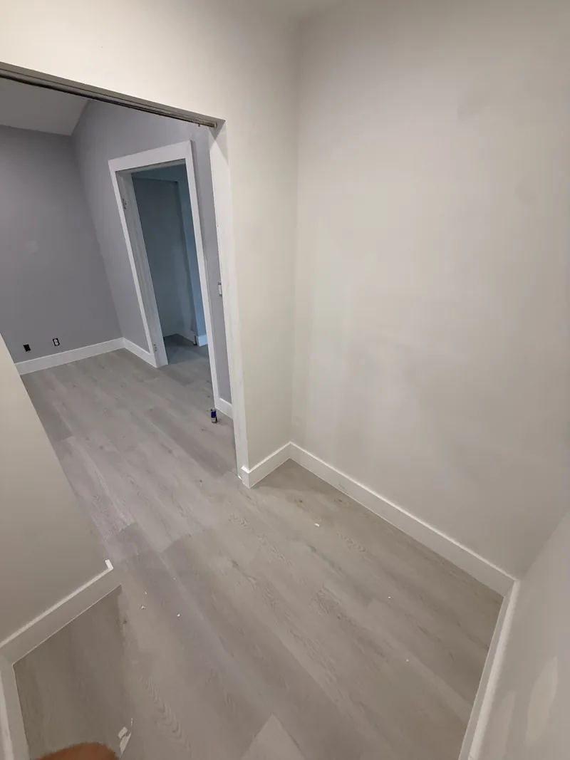 Completed corridor with light flooring and an open doorway
