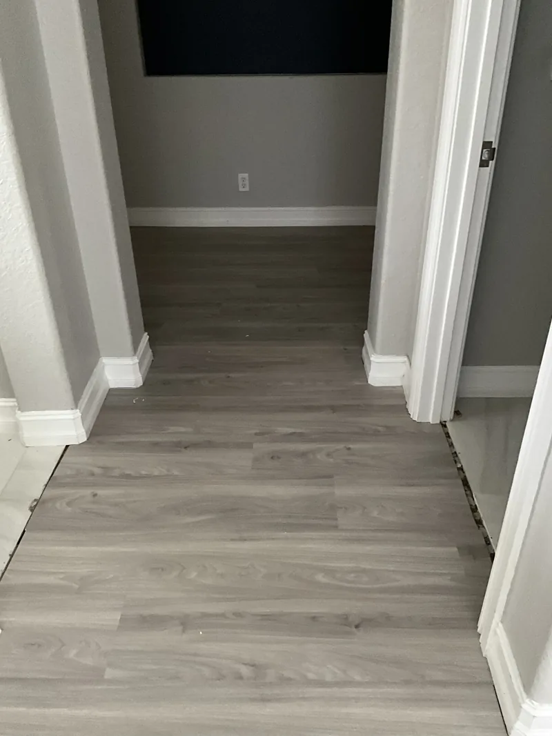 Separate arched corridor documenting the light-toned flooring route