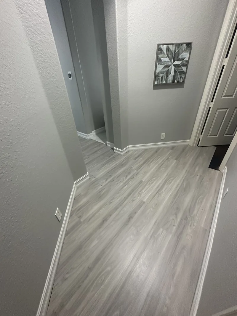 Corridor documenting the light-toned flooring route