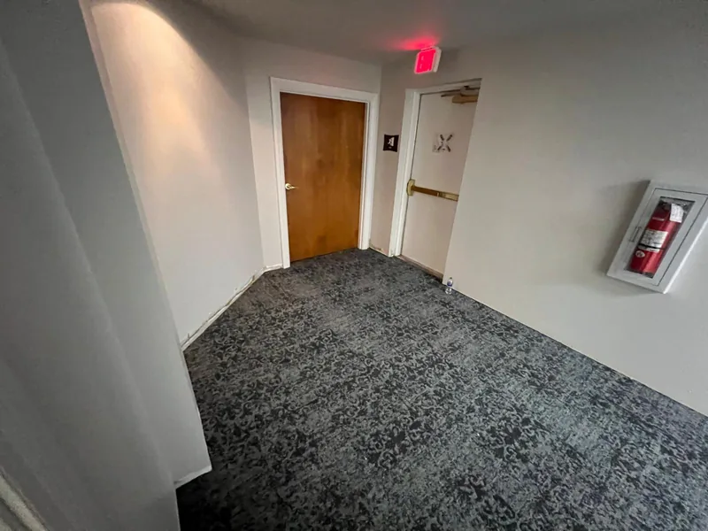 Senior Village corridor with installed carpet flooring at the current project stage