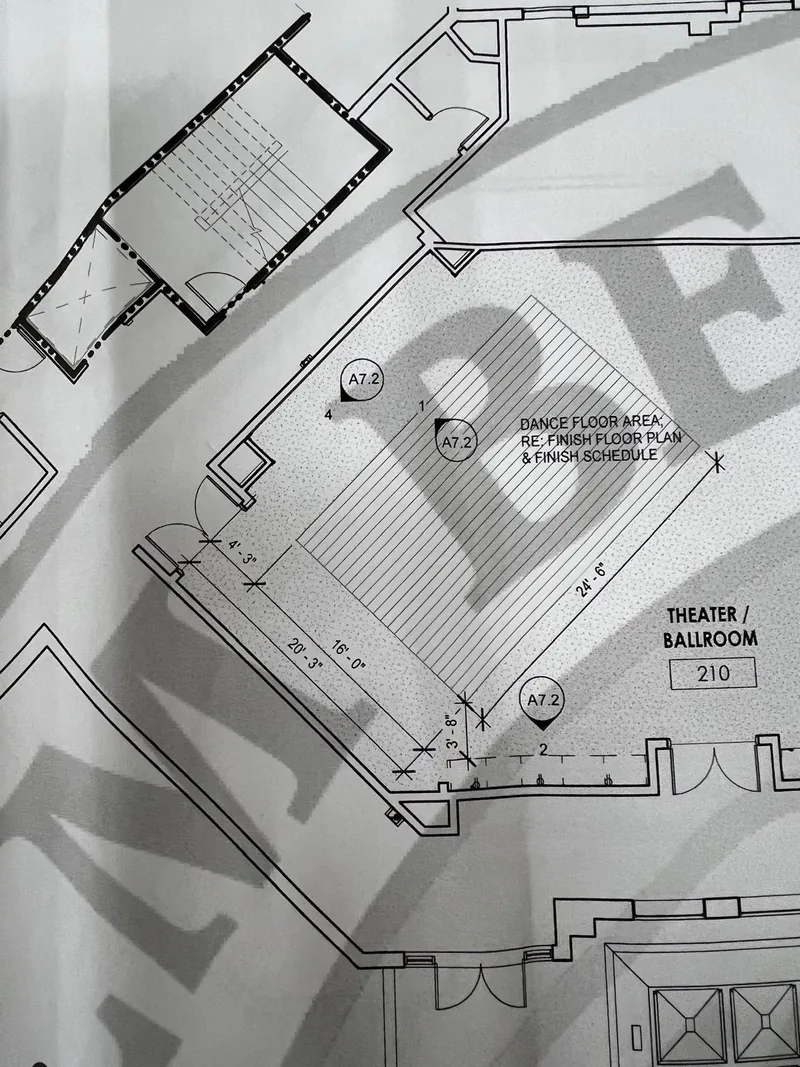 Photographed plan used as visual context for the hall