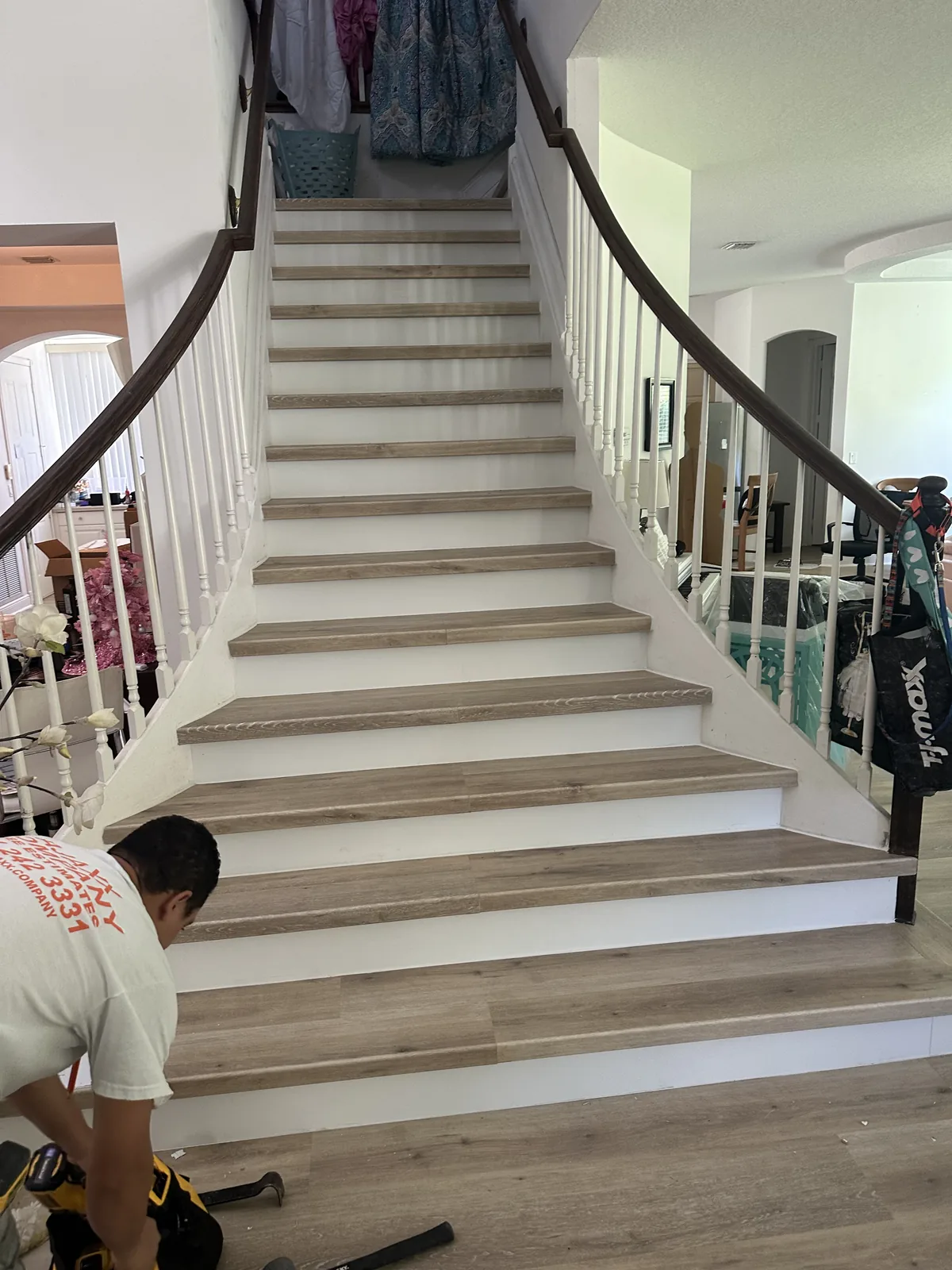 Worker following the curved staircase detail upward