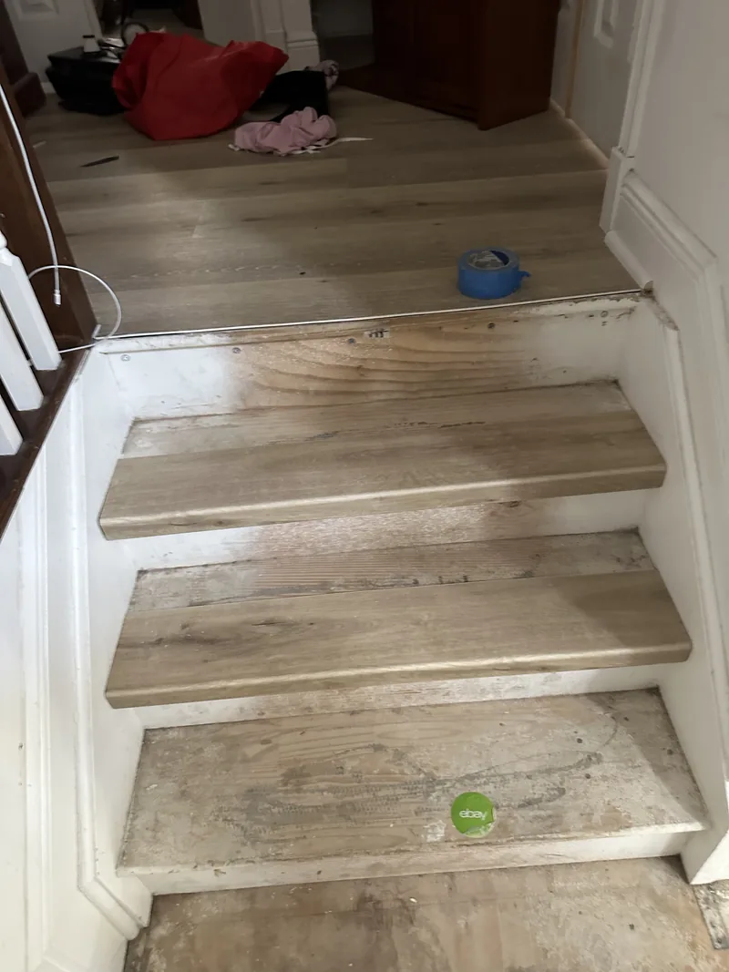 Partial staircase flooring detail following the curved edge