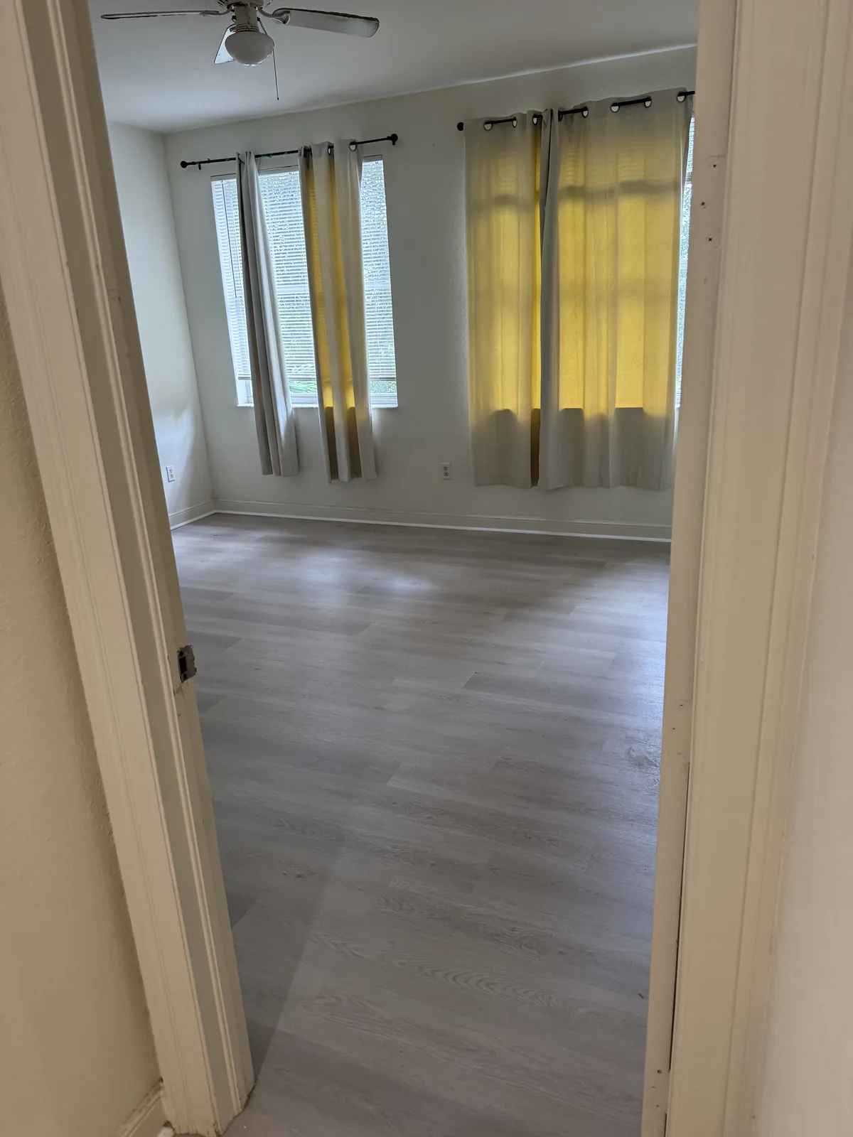Finished bedroom with light flooring under natural light