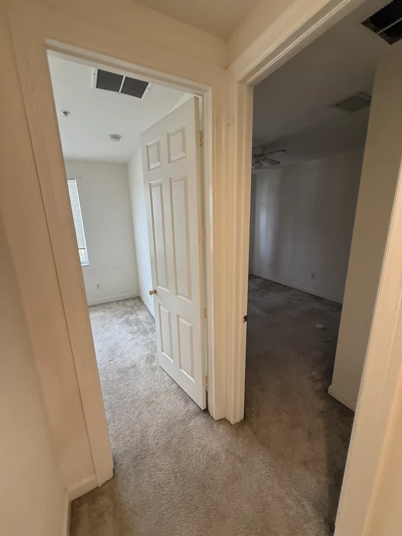 Upper-floor hall with the existing carpet before installation